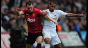 Swansea City's Wayne Routledge battles with Manchester United's Phil Jones
